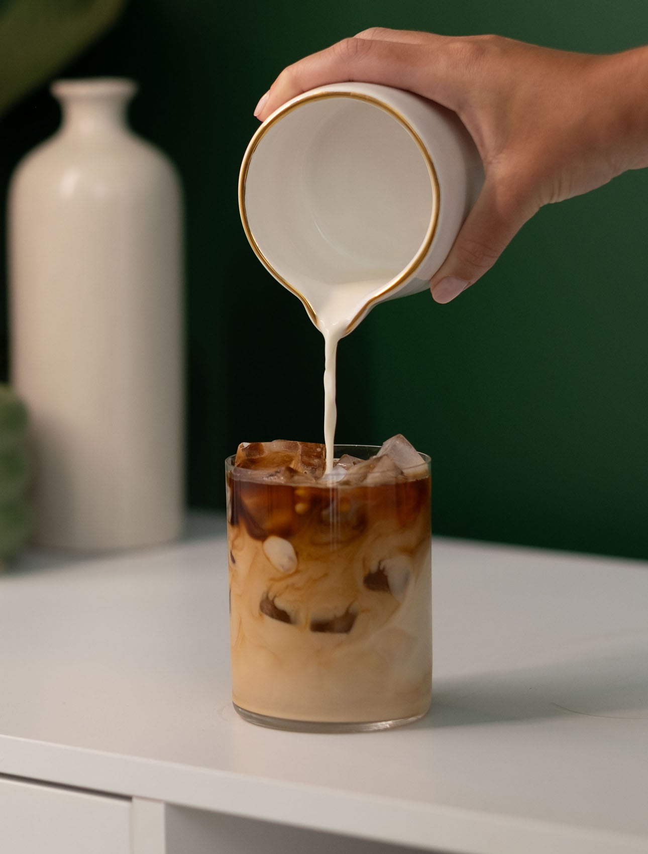 pouring milk into coffee