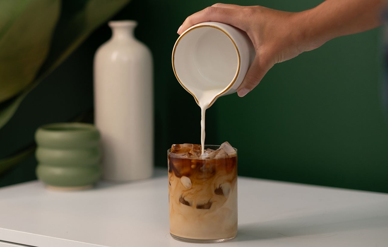 pouring milk into coffee