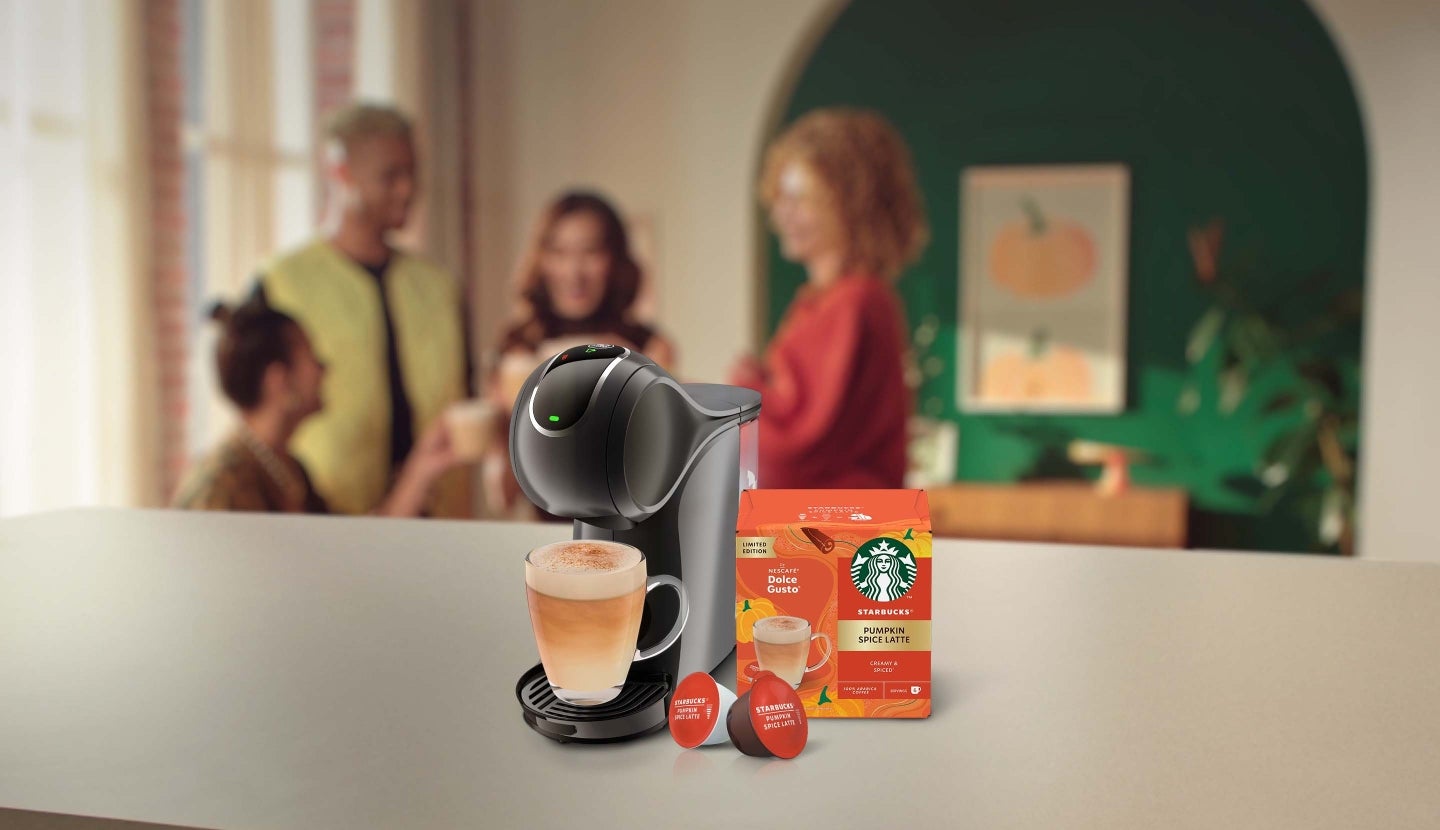 Starbucks® Pumpkin Spice Latte next to a coffee machine