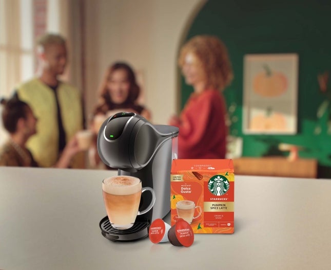 Starbucks® Pumpkin Spice Latte next to a coffee machine