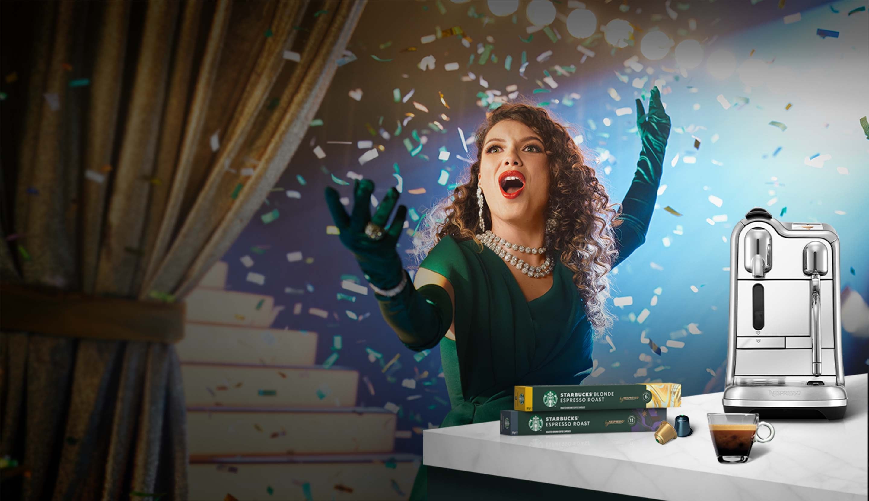 A singing woman performing in her kitchen featuring Starbucks® by Nespresso® coffee, product packs and machine.